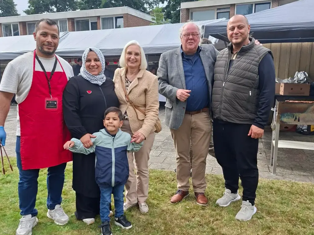 Bezoekers genieten van de najaarsbraderie bij de Şefaat Moskee in Heerenveen, met kleurrijke kraampjes, gerechten en ontmoetingen in een warme sfeer.
